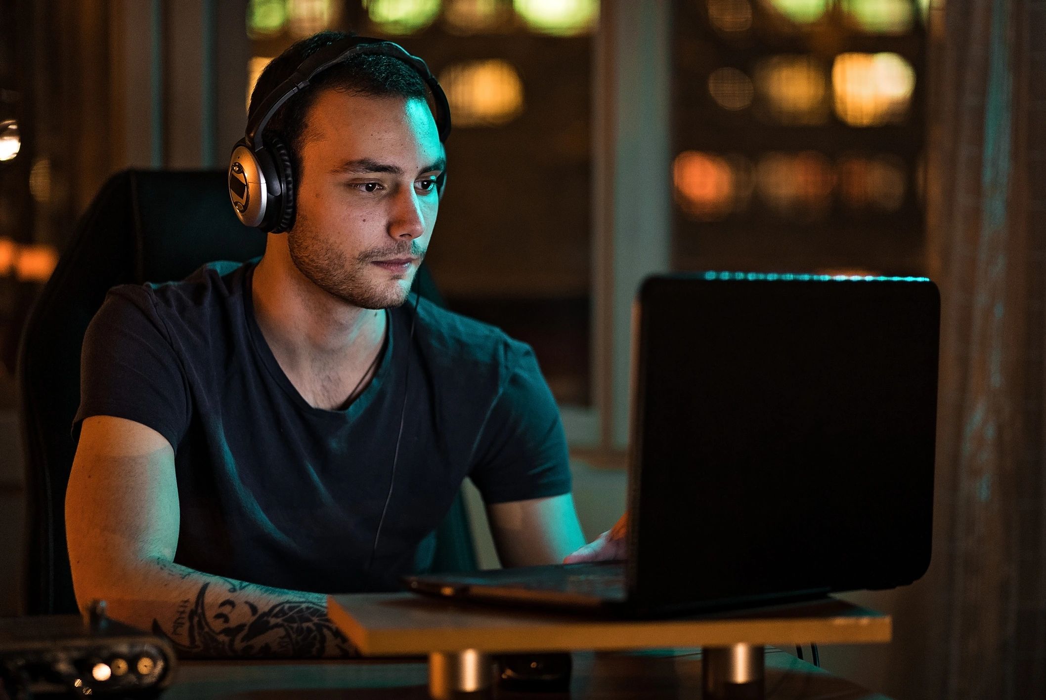 Musician managing tracks on a laptop